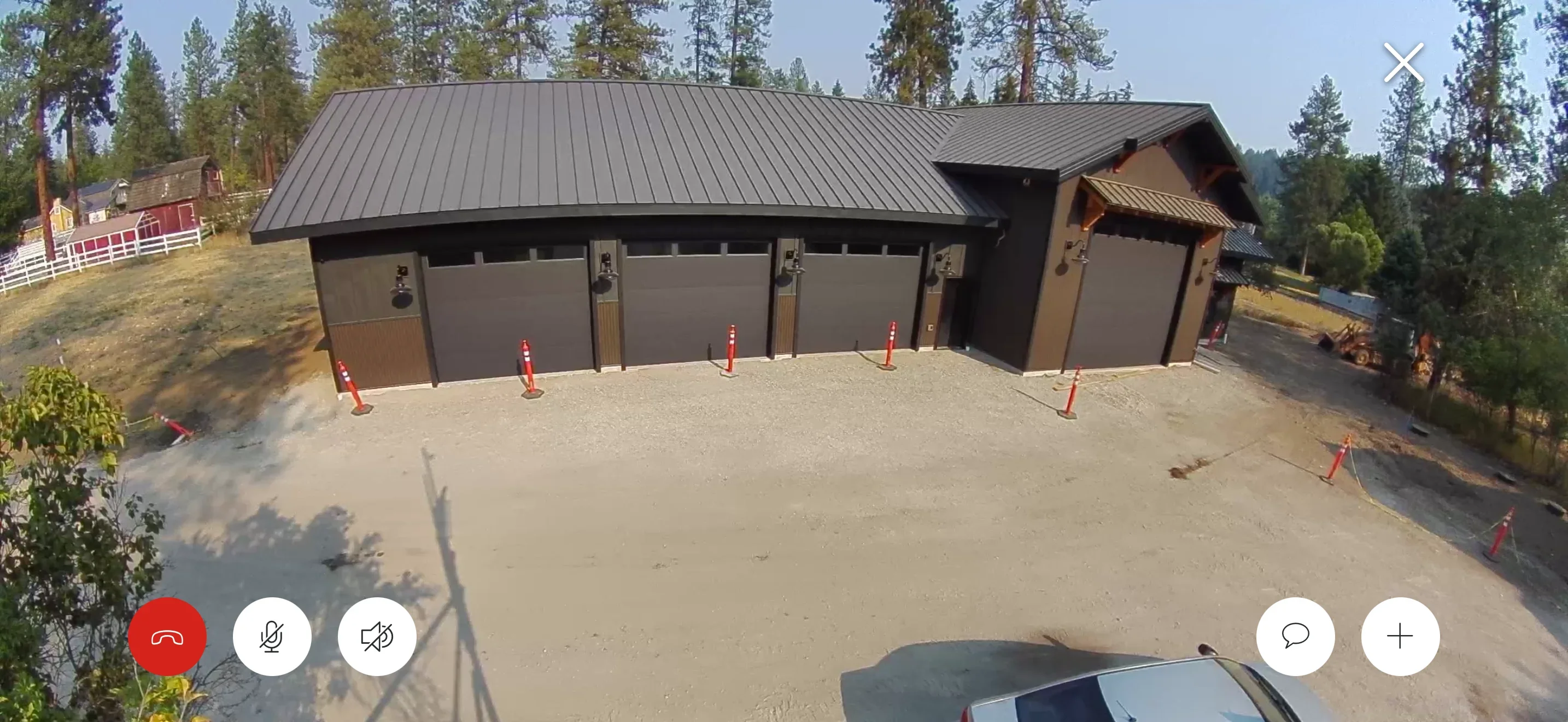 Multi-bay garage with standing seam metal roof and brown exterior walls on concrete pad